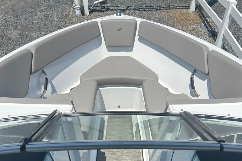 Slide: The Image of 2023 Four Winns H1 OB boat interior with gray cushioned seating and sleek design. - 12