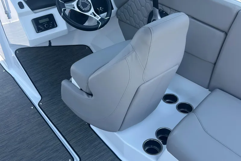 Slide: The Image of 2023 Four Winns H1 OB boat interior with gray seating and steering wheel. - 15