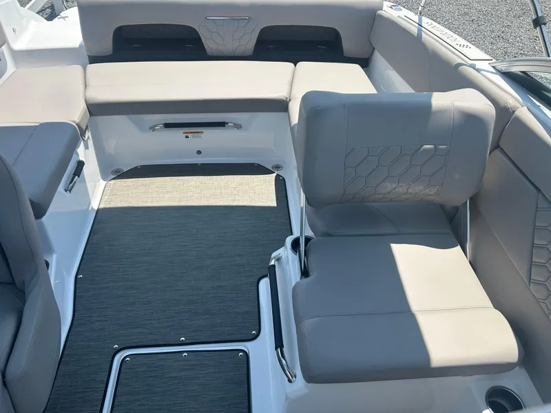 Slide: The Image of 2023 Four Winns H1 OB boat interior with gray seating and modern design. - 16