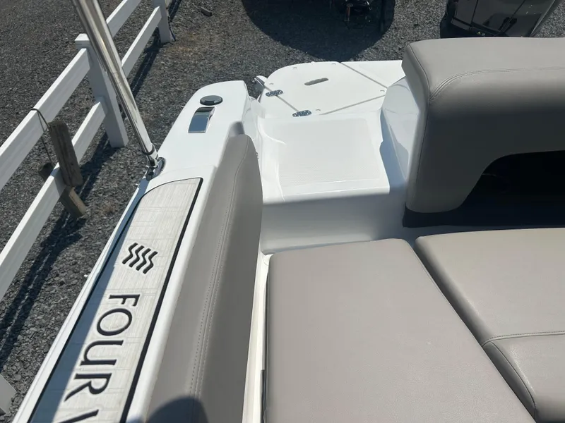 Slide: The Image of 2023 Four Winns H1 OB boat interior with gray seating and branded detailing. - 17