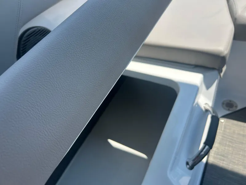 Slide: The Image of 2023 Four Winns H1 OB boat interior storage compartment with cushioned seating. - 18