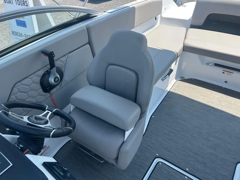 Slide: The Image of 2023 Four Winns H1 OB boat interior with gray seating and steering wheel. - 19
