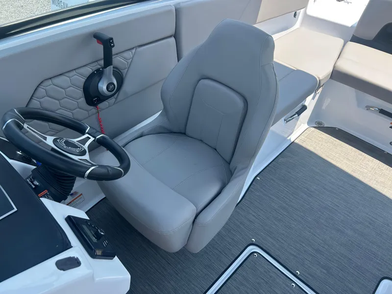 Slide: The Image of 2023 Four Winns H1 OB boat interior with steering wheel and gray seating. - 20