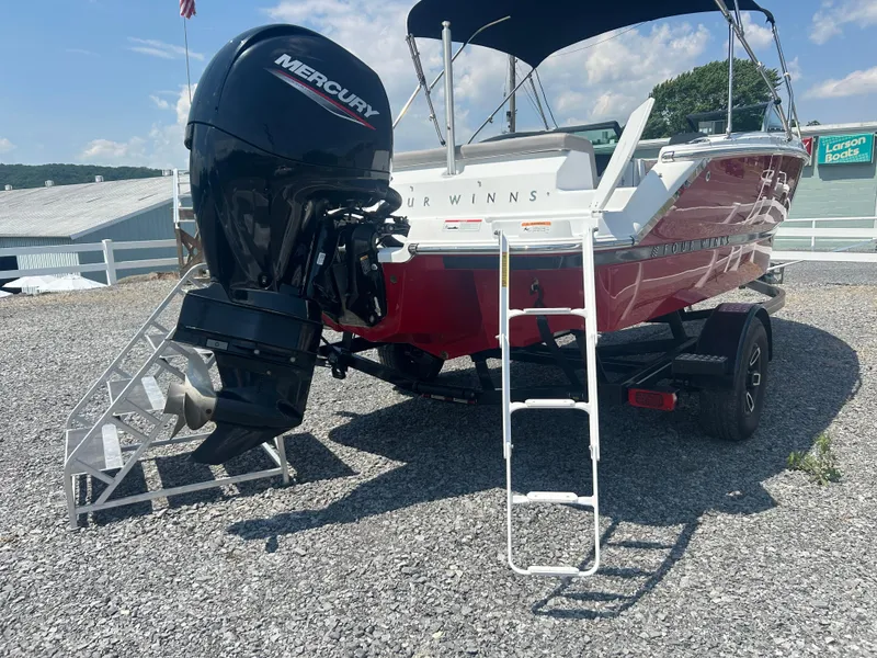 Slide: The Image of 2023 Four Winns H1 OB boat with Mercury outboard engine on gravel lot. - 5