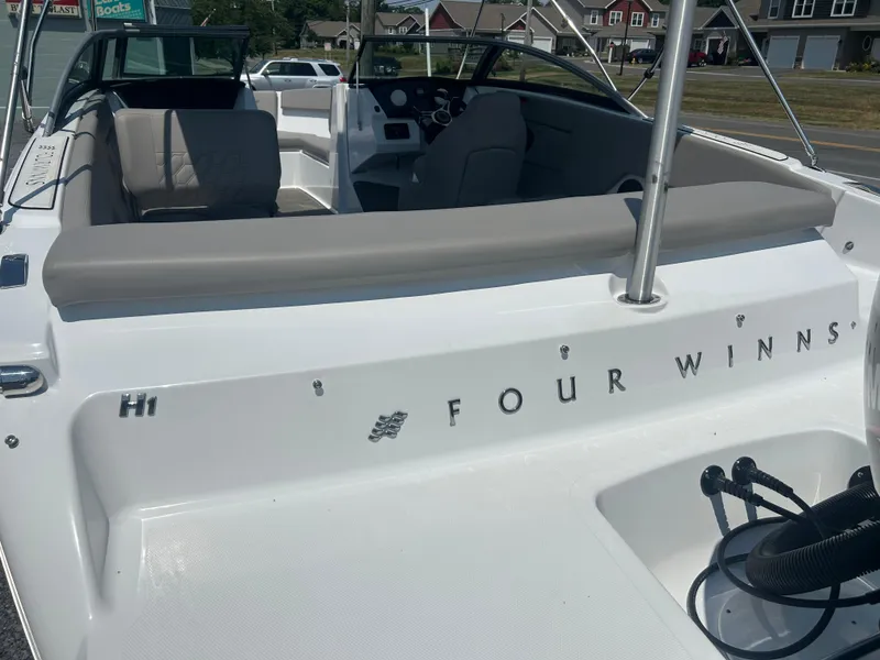 Slide: The Image of 2023 Four Winns H1 OB boat interior with seating and dashboard view. - 6