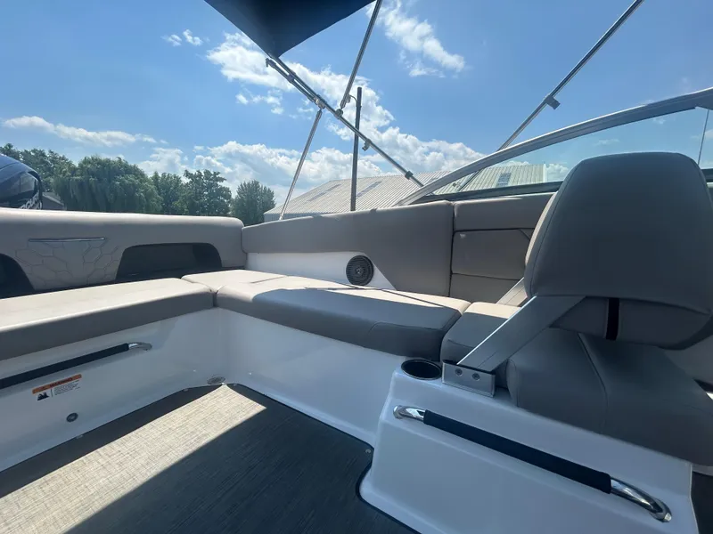 Slide: The Image of 2023 Four Winns H1 OB boat interior with gray seating and sleek design under a blue sky. - 8