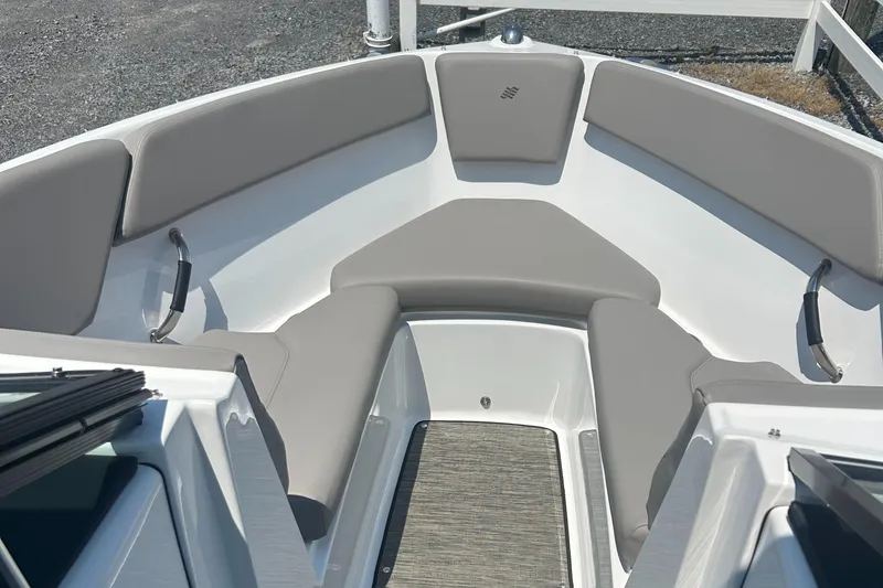 Slide: The Image of 2023 Four Winns H1 OB boat interior with gray cushioned seating and sleek design. - 9
