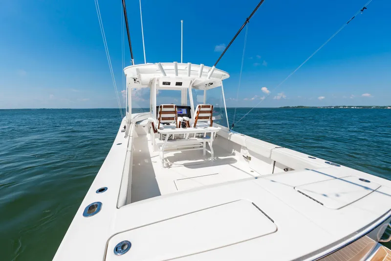 Slide: The Image of 2020 Regulator 34 Center Console boat on open water under clear blue sky. - 12