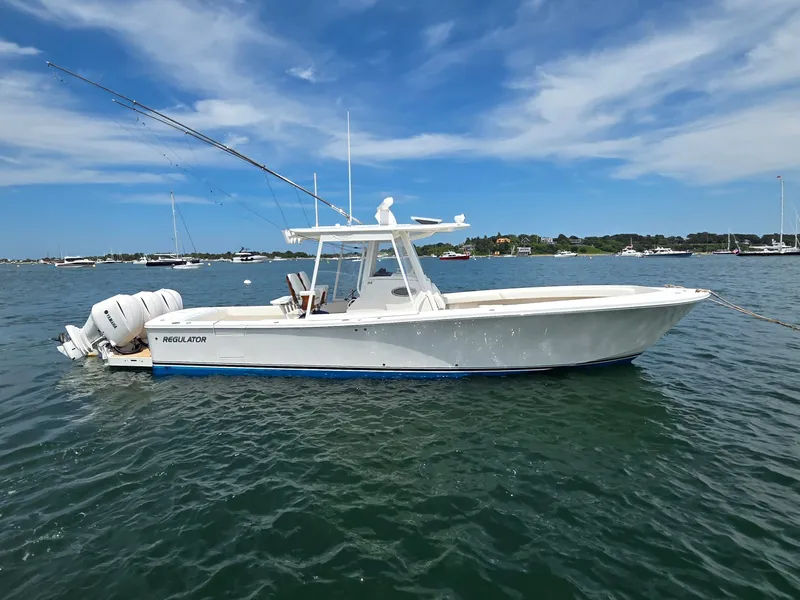 Slide: The Image of 2020 Regulator 34 Center Console boat on calm water under blue sky. - 16
