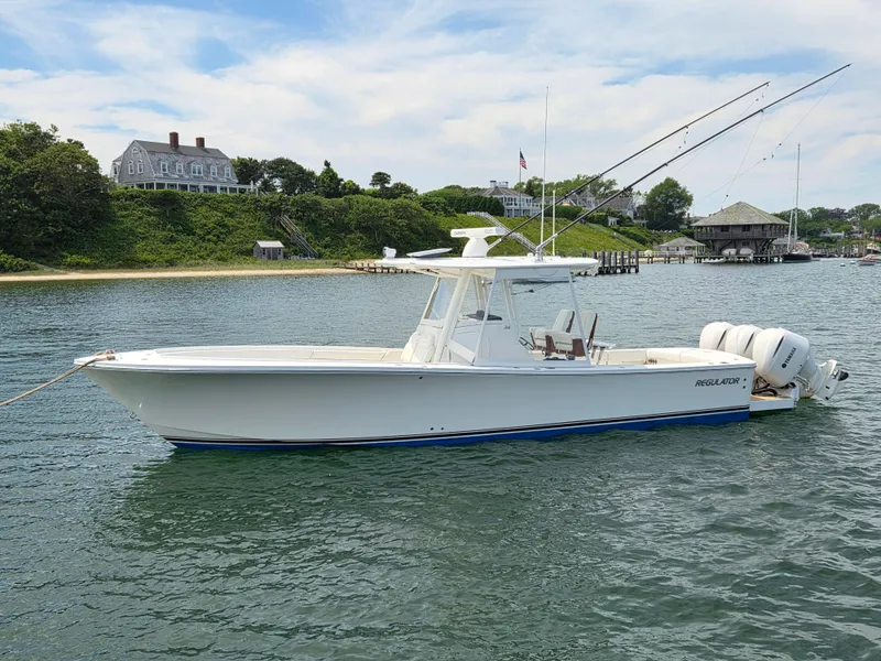 Slide: The Image of 2020 Regulator 34 Center Console boat on water with Yamaha engines. - 2