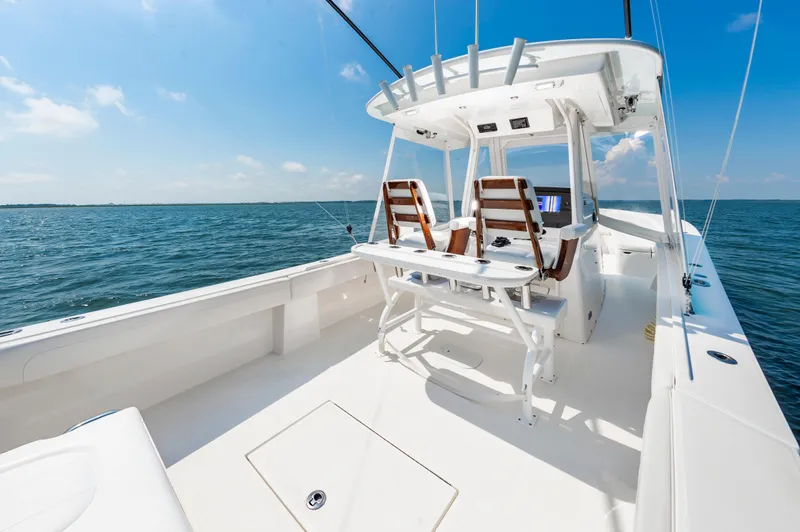 Slide: The Image of 2020 Regulator 34 Center Console boat on open water, featuring sleek design and spacious deck. - 7