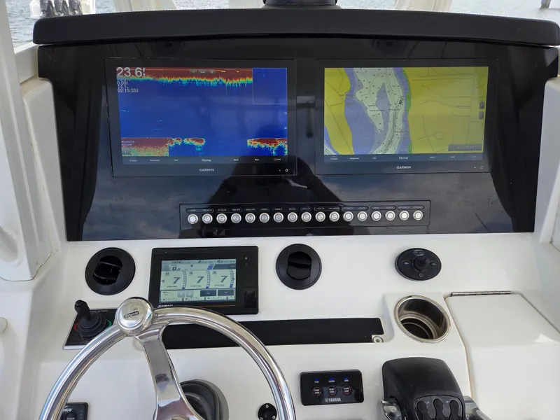 Slide: The Image of 2020 Regulator 34 Center Console dashboard with Garmin navigation displays and controls. - 8