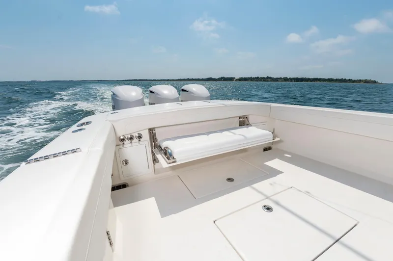 Slide: The Image of 2020 Regulator 34 Center Console boat cruising on open water, clear sky, and distant shoreline. - 9