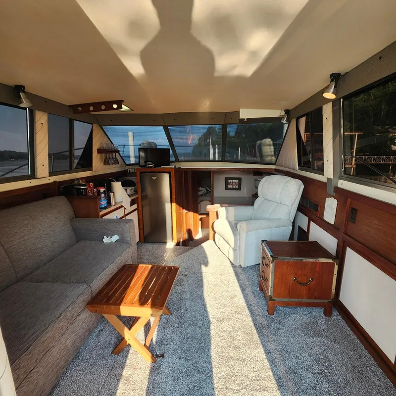 Slide: The Image of Interior of a 1989 Trojan F36 boat with cozy seating and wooden accents. - 10