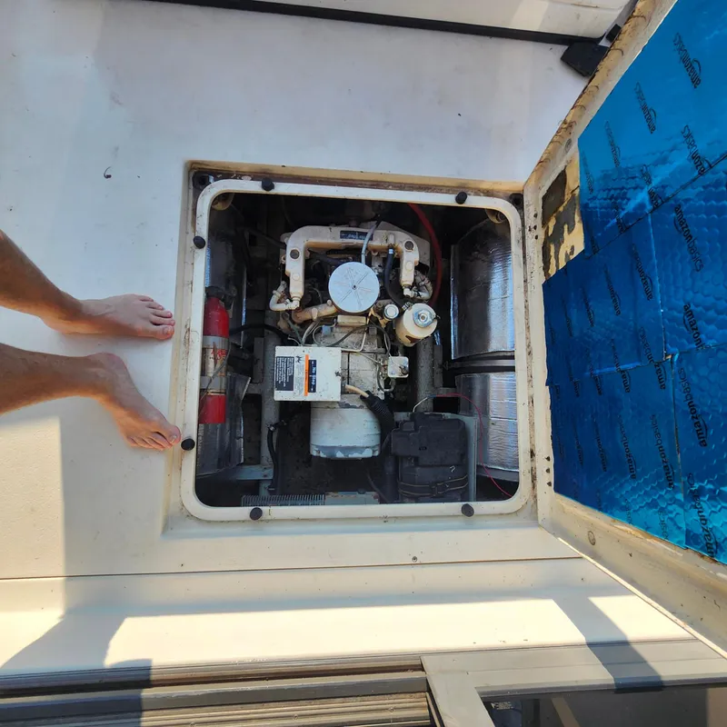 Slide: The Image of Engine compartment of a 1989 Trojan F36 boat with visible components and insulation. - 17