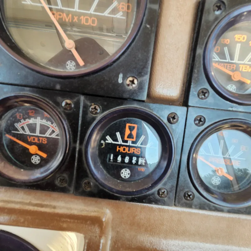 Slide: The Image of Dashboard gauges of a 1989 Trojan F36 boat, showing RPM, volts, hours, and water temperature. - 18