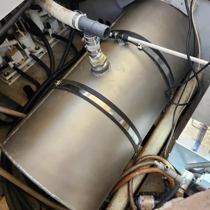Slide: The Image of 1989 Trojan F36 engine room with metal tank and connected hoses. - 24
