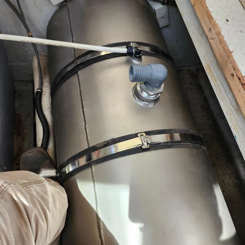 Slide: The Image of 1989 Trojan F36 metal tank with pipes and clamps in a confined space. - 25