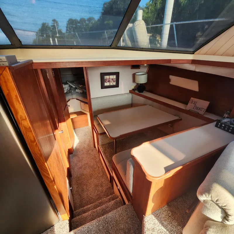 Slide: The Image of Interior of a 1989 Trojan F36 boat with wood finishes and seating area. - 7