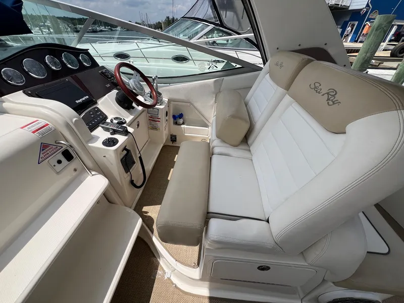 Slide: The Image of Interior of 2010 Sea Ray 330 Sundancer boat with steering wheel and seating. - 12