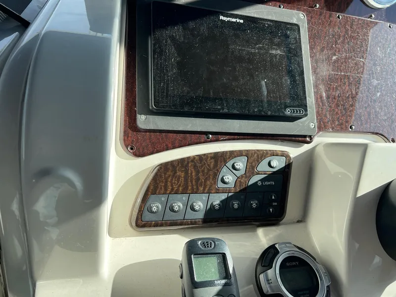 Slide: The Image of Control panel of a 2010 Sea Ray 330 Sundancer boat with navigation equipment. - 16