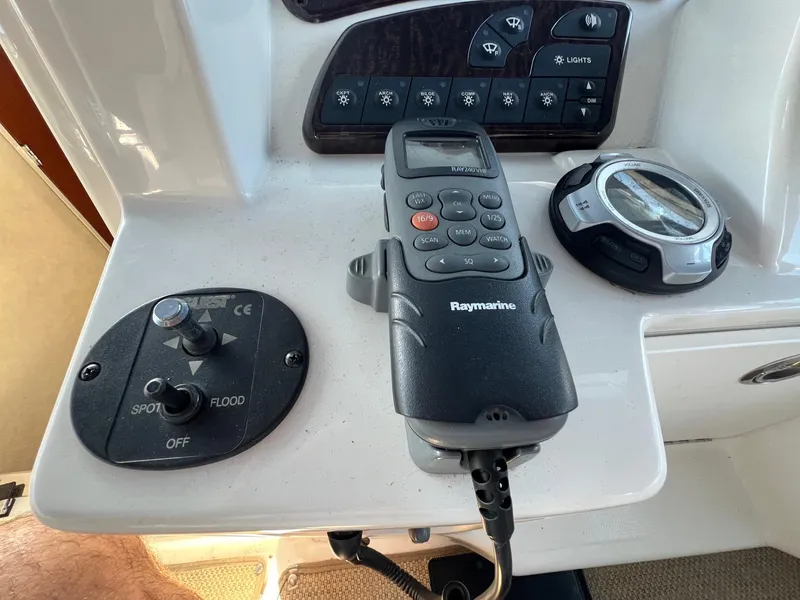 Slide: The Image of Control panel of a 2010 Sea Ray 330 Sundancer with Raymarine device and switches. - 17