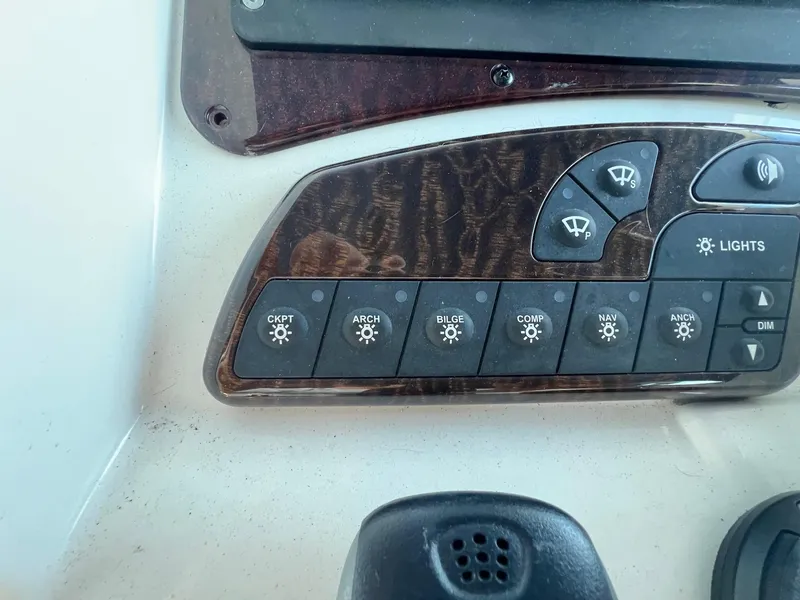 Slide: The Image of Control panel of a 2010 Sea Ray 330 Sundancer boat with various switches. - 18