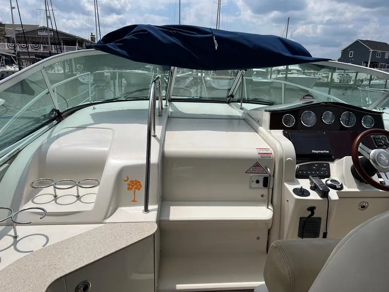 Slide: The Image of 2010 Sea Ray 330 Sundancer boat cockpit with steering wheel and control panel at marina. - 20