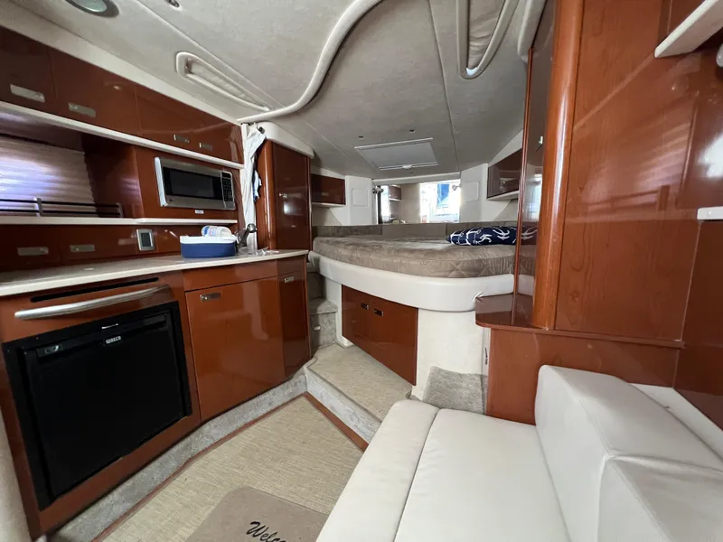 Slide: The Image of Interior of 2010 Sea Ray 330 Sundancer yacht with kitchen and sleeping area. - 21