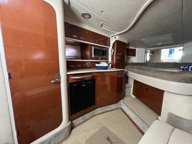 Slide: The Image of Interior of 2010 Sea Ray 330 Sundancer yacht with kitchenette and sleeping area. - 22