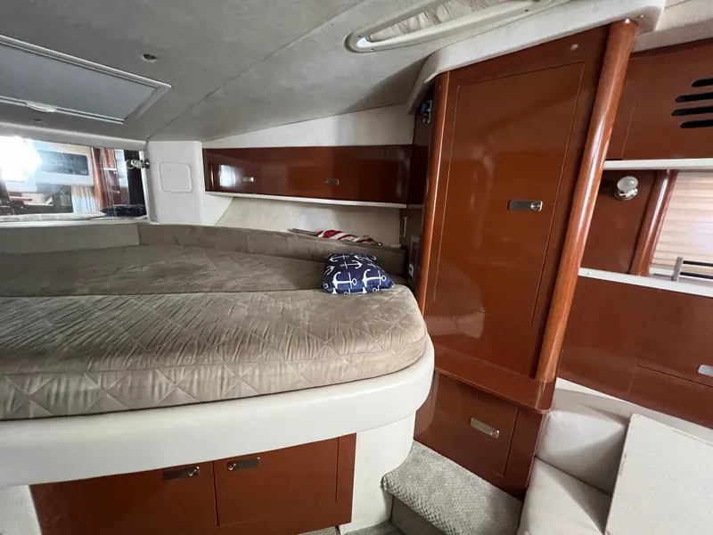 Slide: The Image of Interior cabin of 2010 Sea Ray 330 Sundancer with bed and wooden cabinetry. - 23