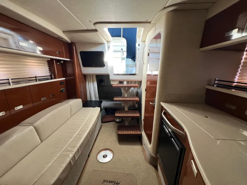 Slide: The Image of Interior of 2010 Sea Ray 330 Sundancer yacht with modern furnishings and compact kitchen. - 24