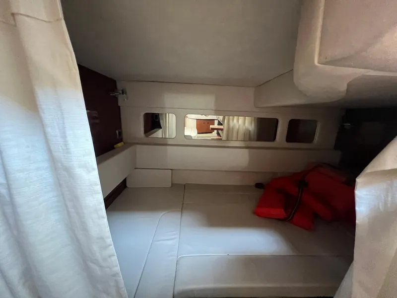 Slide: The Image of Interior cabin of 2010 Sea Ray 330 Sundancer with bed and windows. - 25