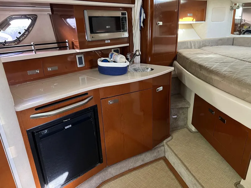 Slide: The Image of Interior of 2010 Sea Ray 330 Sundancer yacht with kitchenette and bed. - 28