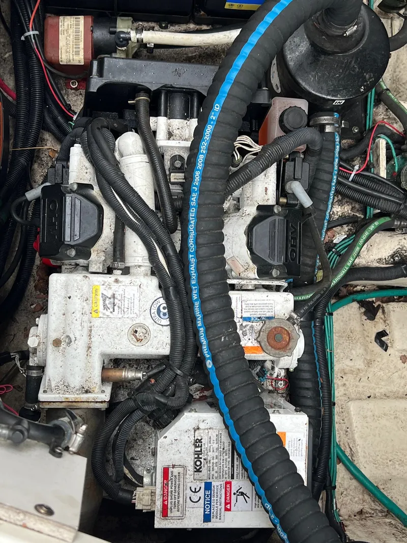 Slide: The Image of Engine compartment of a 2010 Sea Ray 330 Sundancer with visible wiring and components. - 36