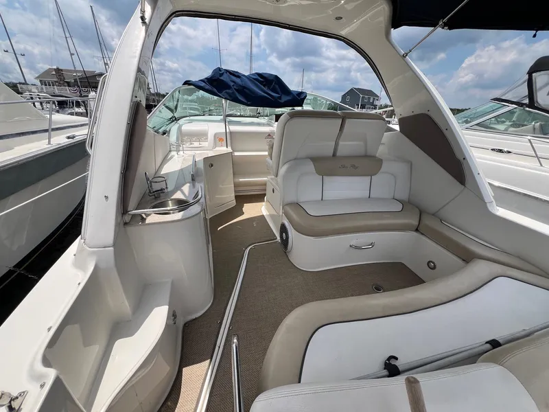 Slide: The Image of 2010 Sea Ray 330 Sundancer interior with beige seating and open deck view. - 5