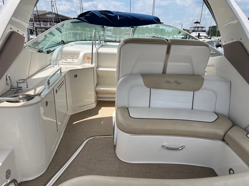 Slide: The Image of Interior of a 2010 Sea Ray 330 Sundancer boat with seating and kitchenette. - 7