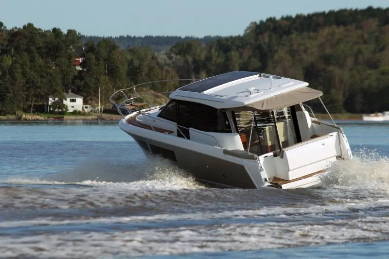 Slide: The Image of 2016 Jeanneau NC 9 motor yacht cruising on a lake. - 20