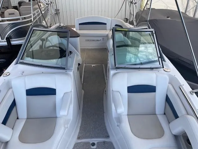 Slide: The Image of 2008 Chaparral Sunesta 264 boat interior with white and blue seating. - 3