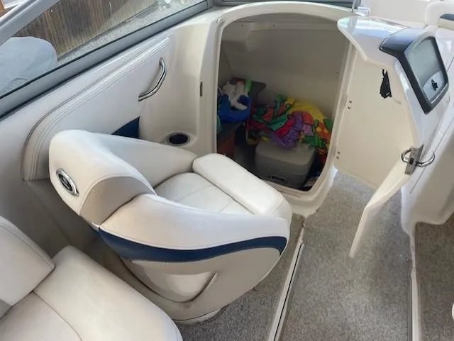 Slide: The Image of 2008 Chaparral Sunesta 264 boat interior with seating and storage compartment. - 8