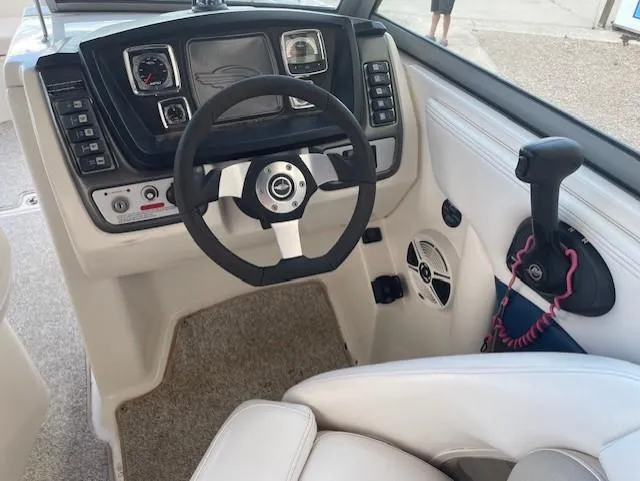 Slide: The Image of 2008 Chaparral Sunesta 264 boat dashboard with steering wheel and control panel. - 9