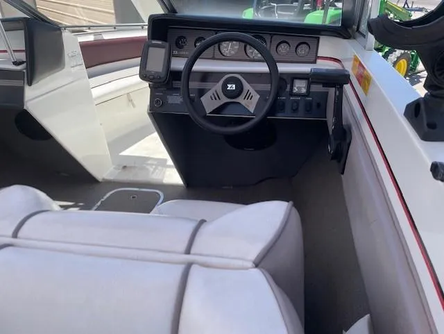 Slide: The Image of Interior of a 1990 Larson 190 I/O boat showing steering wheel and dashboard controls. - 4
