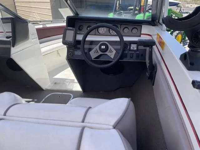 Slide: The Image of Interior of a 1990 Larson 190 I/O boat showing steering wheel and dashboard controls. - 5
