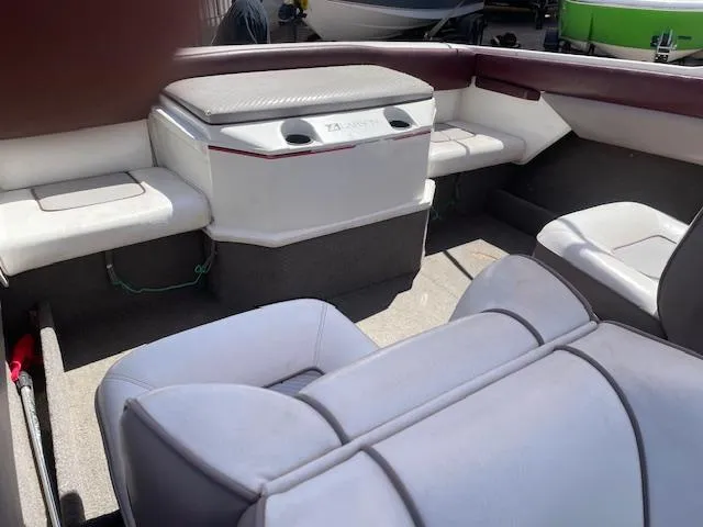 Slide: The Image of Interior of a 1990 Larson 190 I/O boat with cushioned seating and storage. - 6