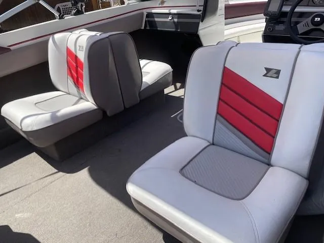Slide: The Image of Interior of a 1990 Larson 190 I/O boat with red and white seating. - 8