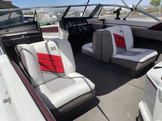 Slide: The Image of Interior of a 1990 Larson 190 I/O boat with red and white seating. - 9