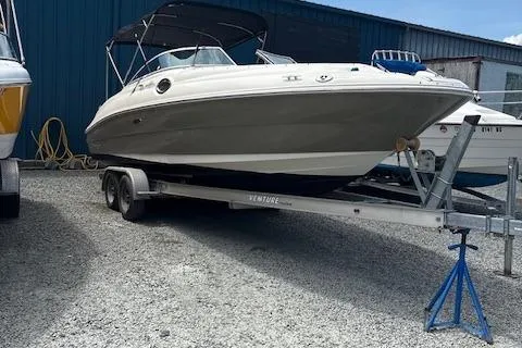 Slide: The Image of 2006 Sea Ray 240SD Bowrider on trailer, parked outdoors, side view. - 2