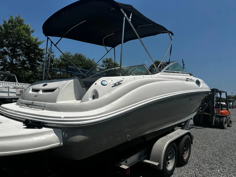 Slide: The Image of 2006 Sea Ray 240SD Bowrider boat on trailer with canopy, parked outdoors. - 3