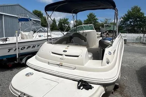Slide: The Image of 2006 Sea Ray 240SD Bowrider boat with canopy, parked outdoors. - 4