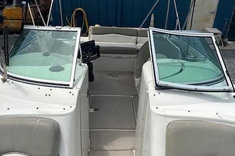 Slide: The Image of 2006 Sea Ray 240SD Bowrider interior with open seating and dual windshields. - 7